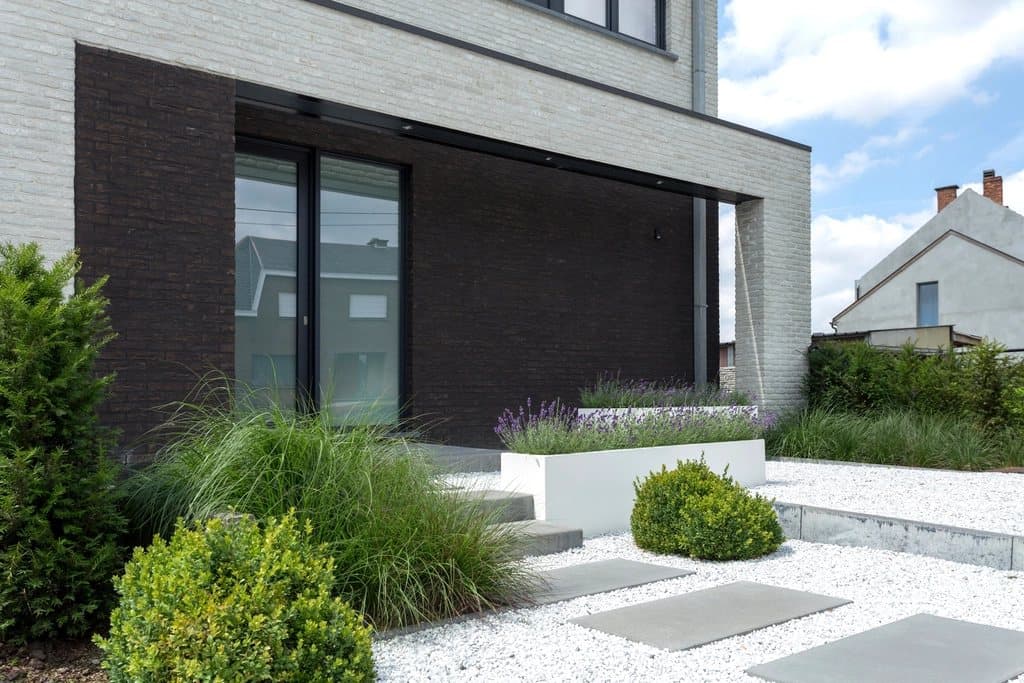 Villa entrance with dark brick, glass doors and stone steps